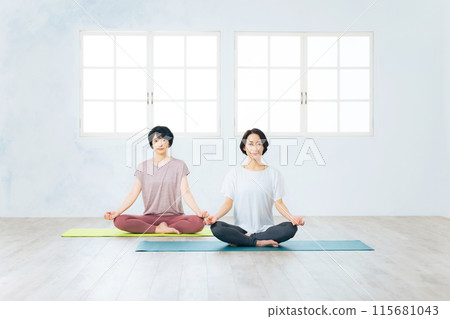 Two middle-aged women doing yoga 115681043