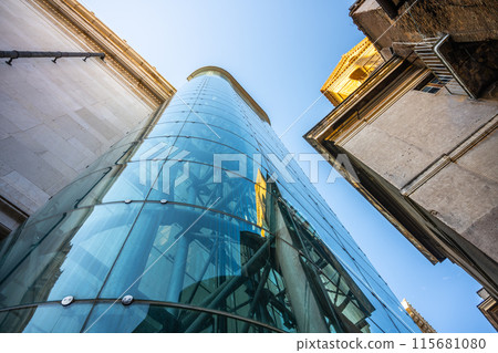 A glass-enclosed panoramic lift at the Victor Emmanuel II National Monument in Rome, Italy. The lift offers stunning views of the city. A glass-enclosed panoramic lift at the Victor Emmanuel II National Monument in Rome, Italy. The lift offers stunning views of the city. 115681080