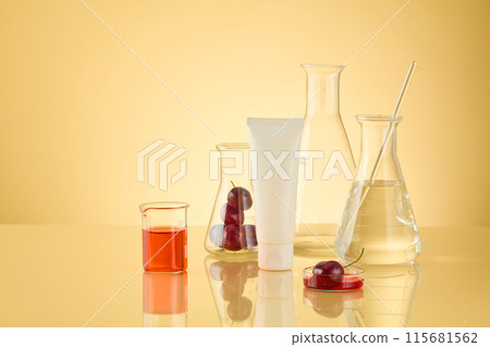 A group of experiment tools consist of erlenmeyer flask filled by transparent liquid and fresh cherry, a beaker of red liquid and a unbranded cosmetic tube displayed on the left, space for designing A group of experiment tools consist of erlenmeyer flask filled by transparent liquid and fresh cherry, a beaker of red liquid and a unbranded cosmetic tube displayed on the left, space for designing 115681562