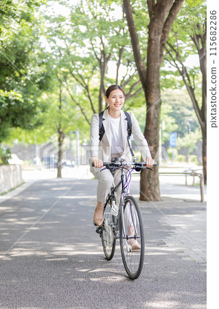 Businesswoman commuting by bicycle image 115682286