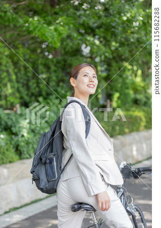 Businesswoman commuting by bicycle image 115682288
