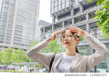 Business woman wiping sweat with a handkerchief 115682315