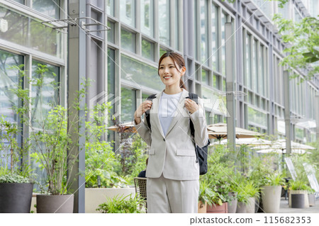 Business woman commuting with a backpack Business woman commuting with a backpack 115682353