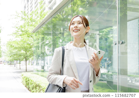 Young woman searching on her smartphone Young woman searching on her smartphone 115682707