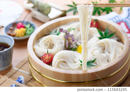 Lifting somen noodles from a tub with chopsticks (somen) Lifting somen noodles from a tub with chopsticks (somen) 115683295