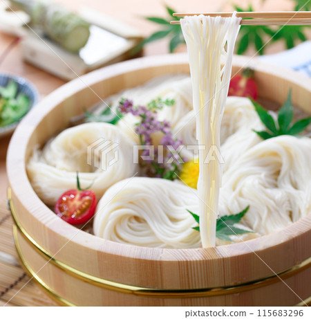 Lifting somen noodles from a tub with chopsticks (somen) Lifting somen noodles from a tub with chopsticks (somen) 115683296