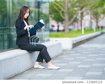 在街角看文件的女商人 115685121