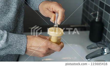 man collects a urine sample, banner format 115685416