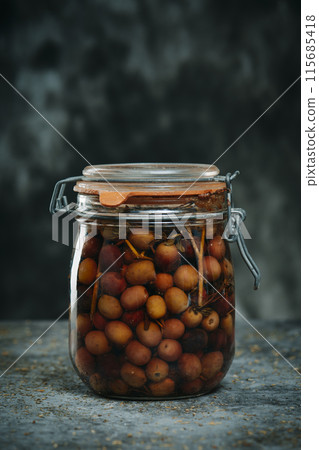 marinated olives in a mason jar with an artight seal 115685418