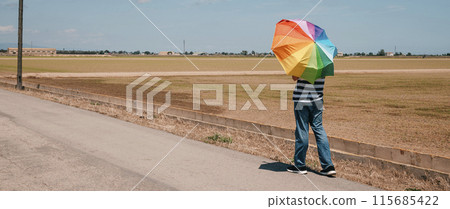 man with a rainbow umbrella, banner format man with a rainbow umbrella, banner format 115685422