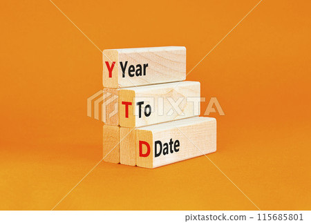 YTD year to date symbol. Concept words YTD year to date on beautiful wooden blocks. Beautiful orange background. Business YTD year to date concept. Copy space. 115685801
