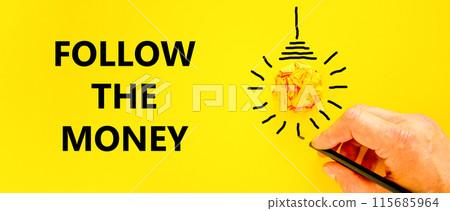 Follow the money symbol. Concept words Follow the money on beautiful yellow paper. Beautiful yellow background. Light bulb icon. Businessman hand. Business and follow the money concept. Copy space. 115685964