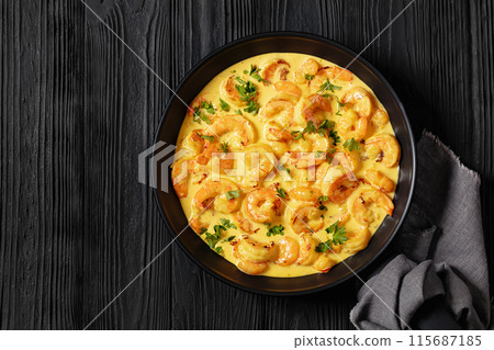 Sauteed Shrimp in creamy saffron sauce, top view 115687185