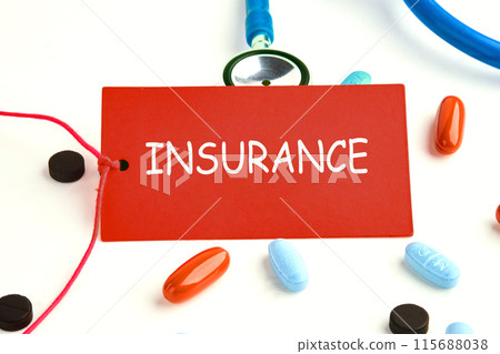 INSURANCE text on a red card on a stethoscope with pills on the surface INSURANCE text on a red card on a stethoscope with pills on the surface 115688038