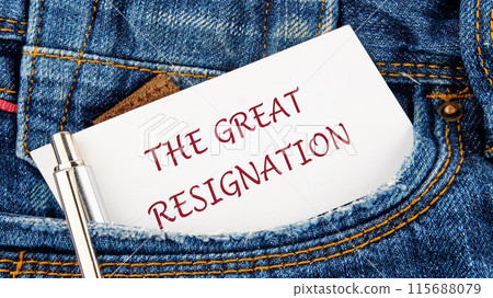 Text THE GREAT RESIGNATION on a piece of paper from a jeans pocket Text THE GREAT RESIGNATION on a piece of paper from a jeans pocket 115688079