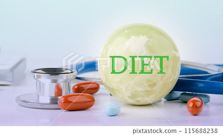Diet and Healthy food concept. DIET written on a ball on a blue background with pills and a stethoscope in the composition 115688238