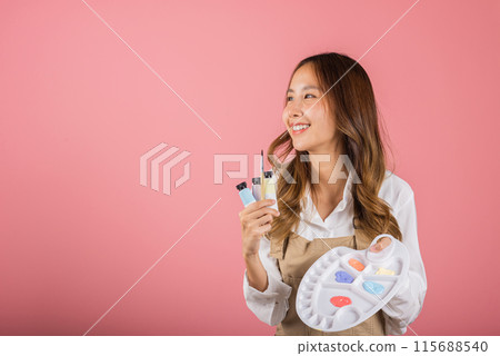 Asian beautiful young woman artist holding brush and paint palette, Happy female painting using paintbrush and palette with colors, studio shot isolated on pink background, Paintings and art equipment Asian beautiful young woman artist holding brush and paint palette, Happy female painting using paintbrush and palette with colors, studio shot isolated on pink background, Paintings and art equipment 115688540