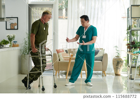 Doctor Supporting Injured Soldier in Rehabilitation 115688772