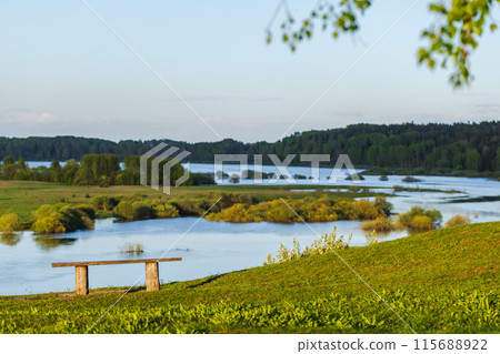Rural Russian landscape photo with an empty wooden bench Rural Russian landscape photo with an empty wooden bench 115688922