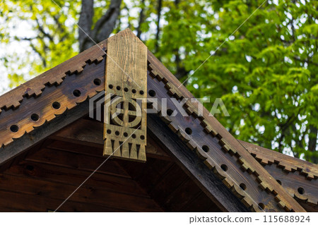 Slavic wooden decoration elements on the gable 115688924