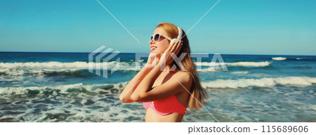 Summer vacation of relaxed happy woman enjoying listening to music with headphones on beach at sea 115689606