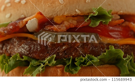 Delicious cheeseburger with cheese, lettuce, tomato, red onion and bun. 115689943
