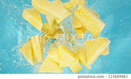 Freeze Motion of Pineapple Slices Falling into Water, Splashing. 115689961