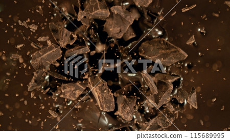 Freeze motion of flying group of raw chocolate pieces. 115689995