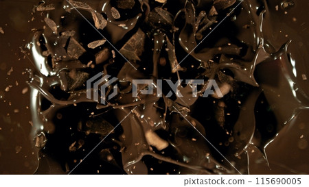 Freeze motion of flying group of raw chocolate pieces. Freeze motion of flying group of raw chocolate pieces. 115690005