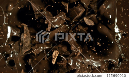 Freeze motion of flying group of raw chocolate pieces. Freeze motion of flying group of raw chocolate pieces. 115690010