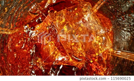 Closeup of ice cube inside glass of whiskey. Closeup of ice cube inside glass of whiskey. 115690025