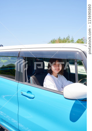 A young woman riding a car A young woman riding a car 115690860