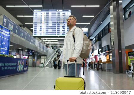 Young Caucasian male passenger in stylish casual clothes using smartphone and laptop keyboard, sit has training online meeting on laptop computer in airline lounge wait transit international airport 115690947