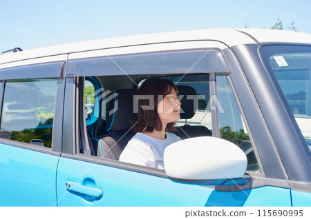 A young woman riding a car 115690995
