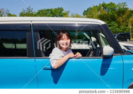 A young woman riding a car 115690996