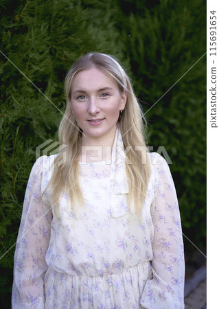 portrait of a young blonde woman in a pastel chiffon dress portrait of a young blonde woman in a pastel chiffon dress 115691654