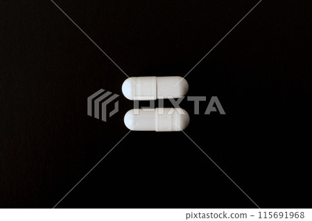 Pills. White pills, medical capsules. Isolated on a black background. An allergy pill, antibiotics, supplements. Medicine, healthcare concept. Virus(viral) and flu diseases. High quality photo Pills. White pills, medical capsules. Isolated on a black background. An allergy pill, antibiotics, supplements. Medicine, healthcare concept. Virus(viral) and flu diseases. High quality photo 115691968