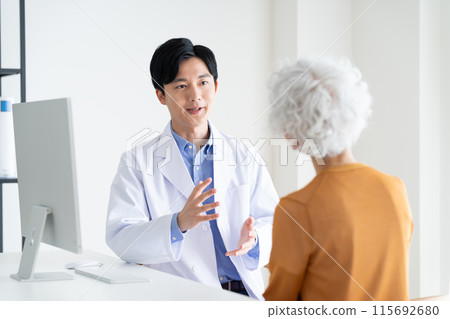 Young doctor examining a senior woman 115692680
