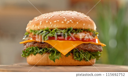 Close-up of home made tasty burgers on old olive wooden table. Close-up of home made tasty burgers on old olive wooden table. 115692752