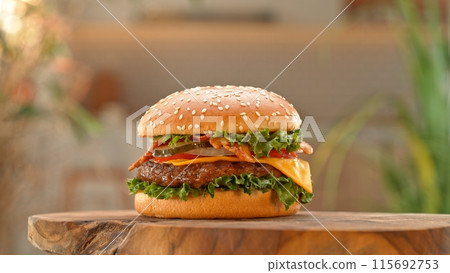 Close-up of home made tasty burgers on old olive wooden table. Close-up of home made tasty burgers on old olive wooden table. 115692753