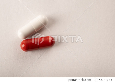 Pills. Medical pills and capsules. Red capsule. Isolated on a pink background. An allergy pill, antibiotics, supplements. Medicine, healthcare concept. Virus(viral), flu diseases. High quality photo 115692773