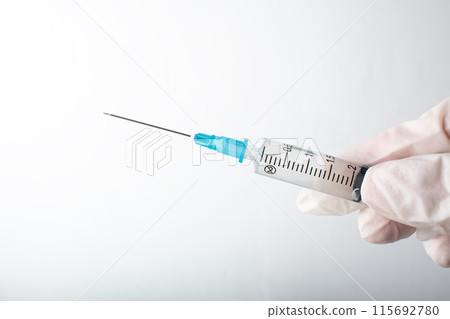 Syringe in hand close up. Medical injection isolated on white. Medicine vaccination equipment. Consumables for injection, virus protection. Diseases, medical care. Copy space. High quality photo Syringe in hand close up. Medical injection isolated on white. Medicine vaccination equipment. Consumables for injection, virus protection. Diseases, medical care. Copy space. High quality photo 115692780