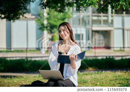 A young lady who makes notes in the notebook A young lady who makes notes in the notebook 115693078
