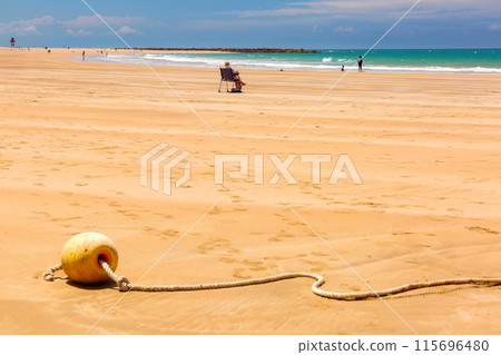 Sandy city beach in Cadiz on a sunny day. Sandy city beach in Cadiz on a sunny day. 115696480