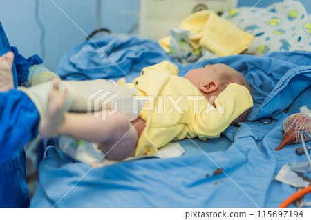 A nurse caring for a newborn baby in a hospital setting. The nurse provides gentle and attentive care, ensuring the baby's comfort and well-being A nurse caring for a newborn baby in a hospital setting. The nurse provides gentle and attentive care, ensuring the baby's comfort and well-being 115697194
