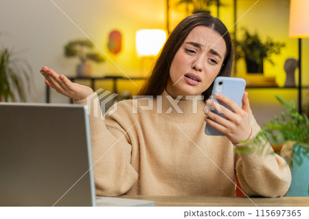 Sad pretty woman use smartphone surprised by bad news, fortune loss, fail, lottery results, deadline Sad pretty woman use smartphone surprised by bad news, fortune loss, fail, lottery results, deadline 115697365
