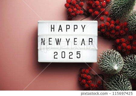 Happy New Year 2025 word in light box on pink background Happy New Year 2025 word in light box on pink background 115697425