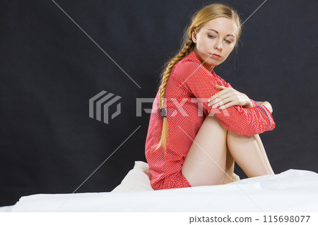 Sad depressed young woman in bed 115698077