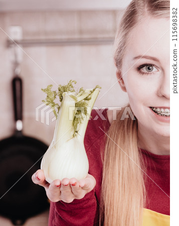 Happy woman holding green fennel Happy woman holding green fennel 115698382
