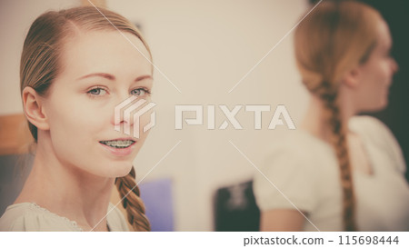 Happy woman reflecting in mirror Happy woman reflecting in mirror 115698444